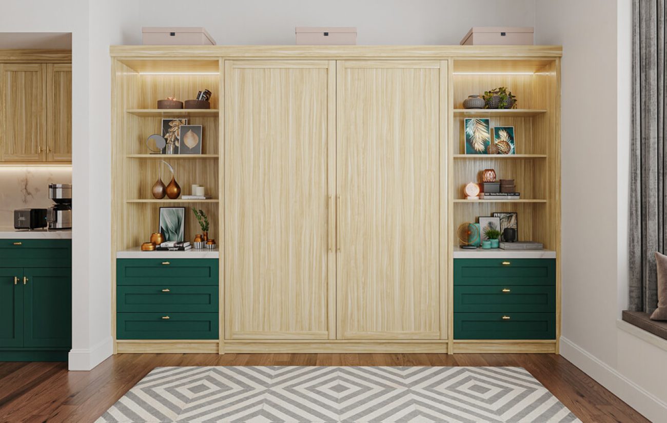 Light woodgrain wall bed closed with flanking green drawer units and open shelving for accessories and décor.