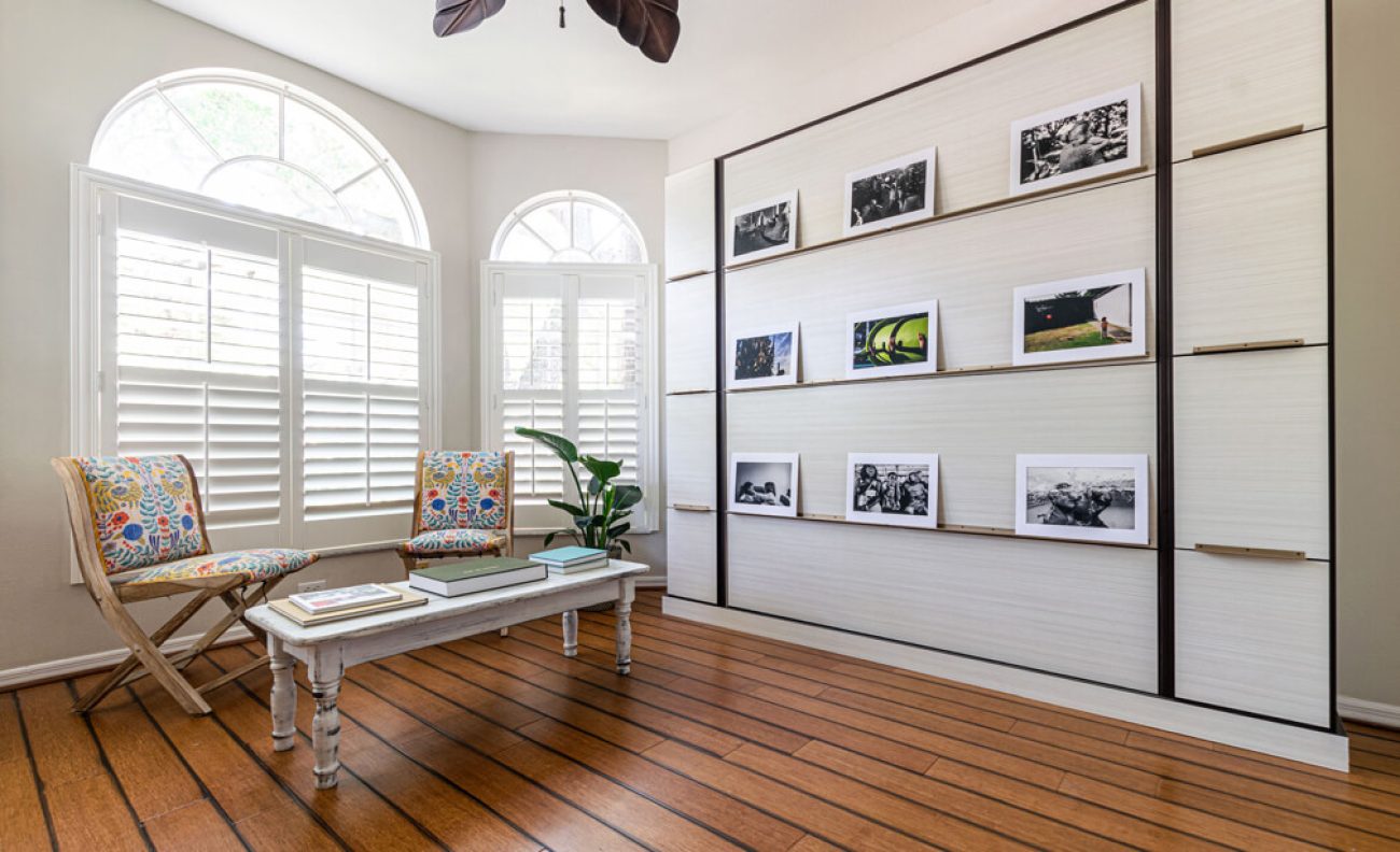 Wall bed disguised as a photo gallery installation