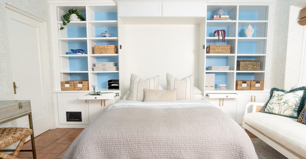 Custom Murphy Bed with white built-in cabinetry and pull-out desk with strip lighting