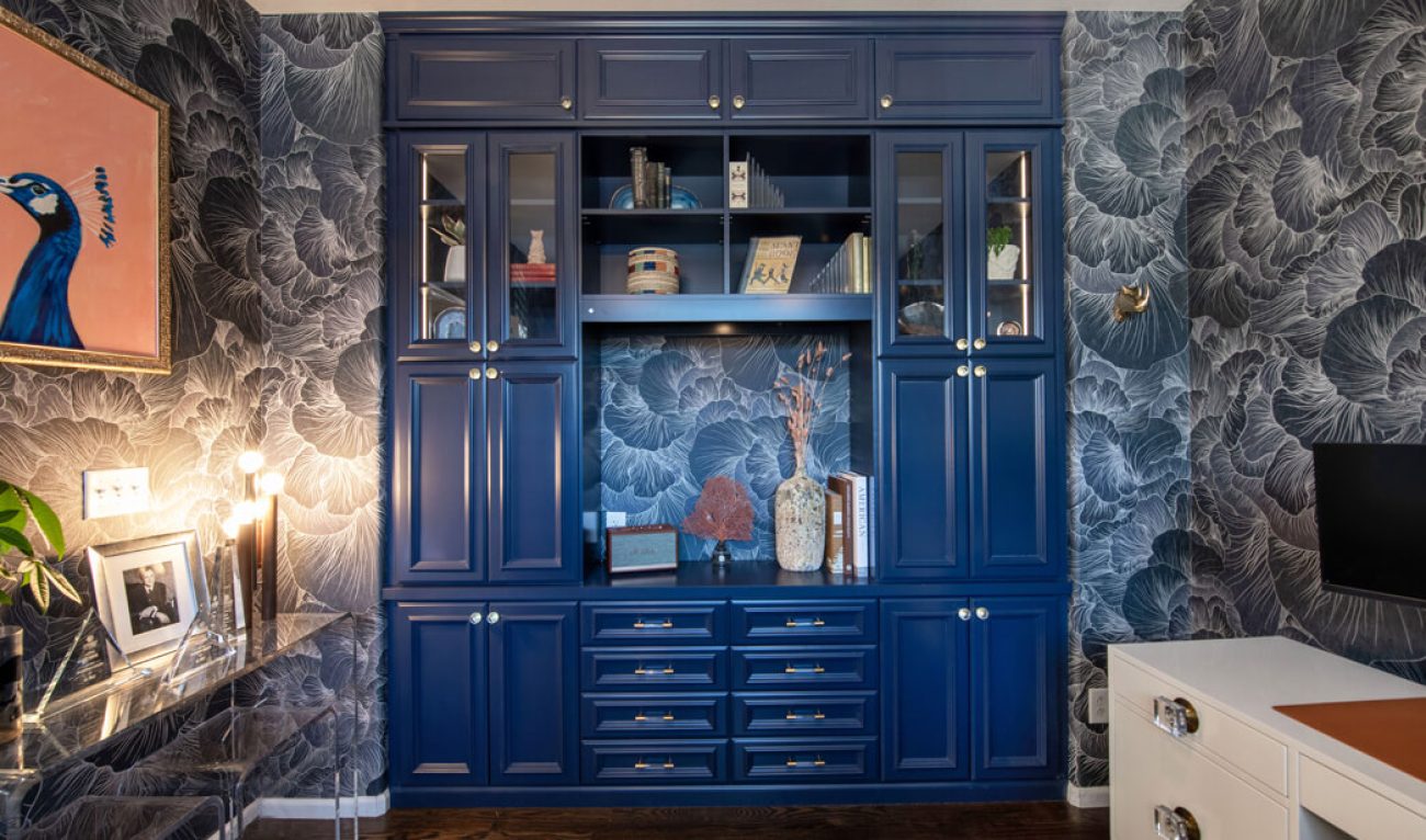 Elegant navy blue built-in cabinetry with glass doors and open shelving