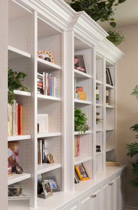 White built-in bookcase with crown molding and lower cabinetry