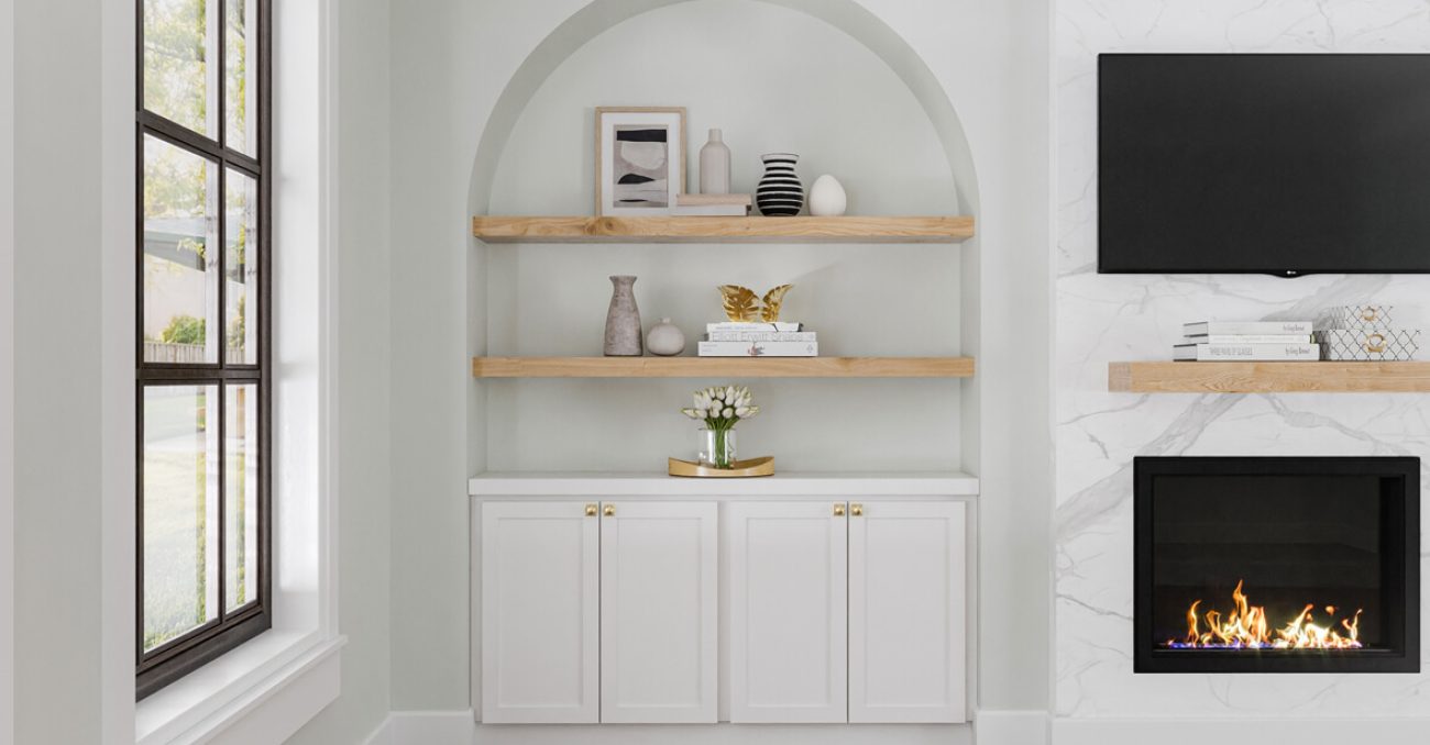 Modern alcove wall unit with light wood floating shelves and white lower cabinetry