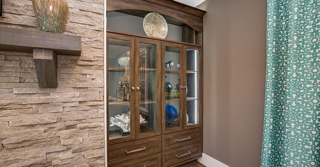 Built-in wall unit in Rocky Mountain with LED light strips and glass inserts.