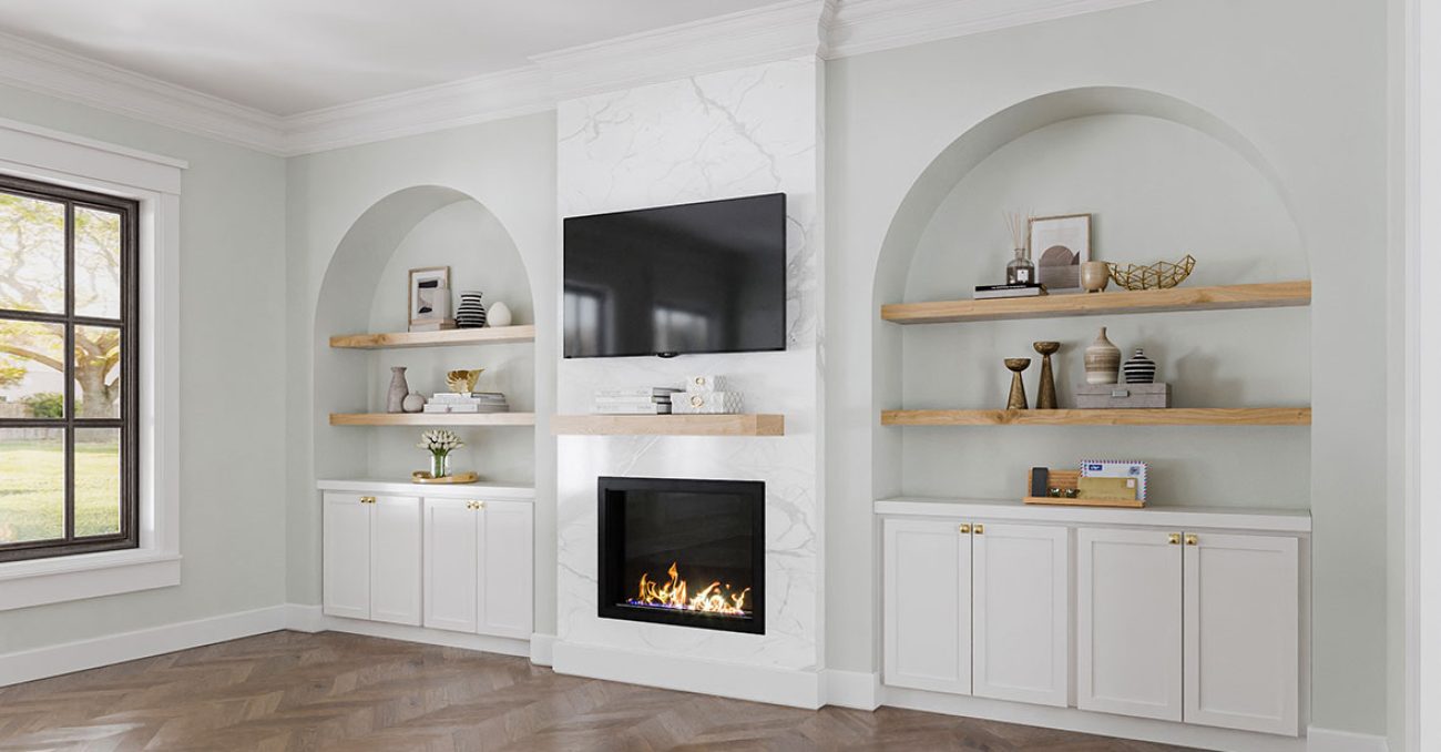 White base cabinets and wood floating shelving.