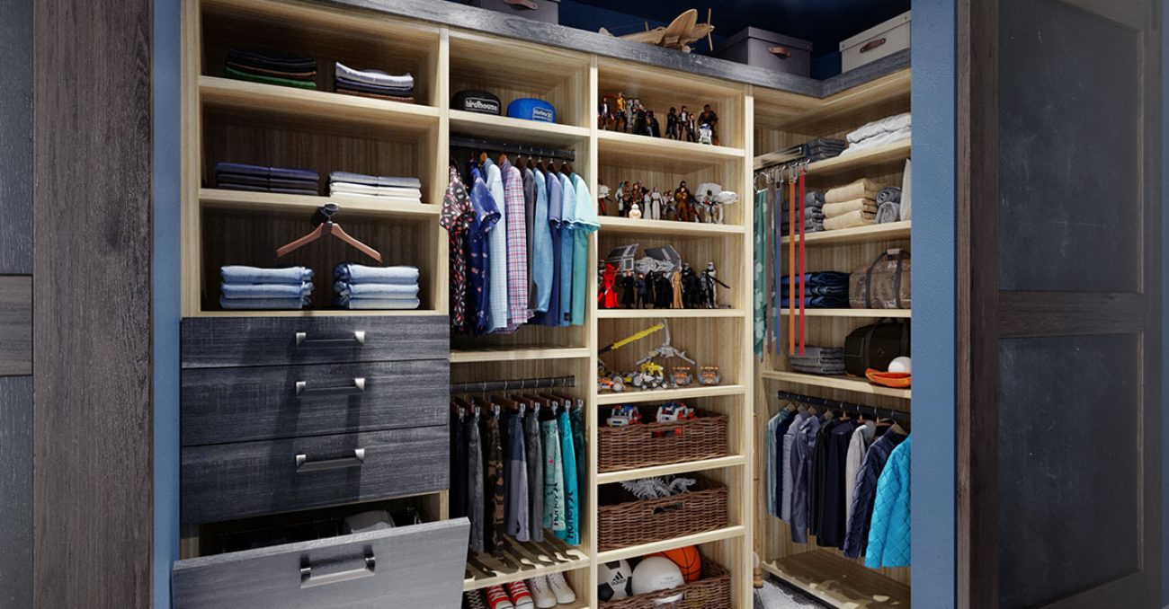 Children's clothing in reach-in closet featuring pull-out tie rack, dual level hanging rods, upper storage, and woven baskets.
