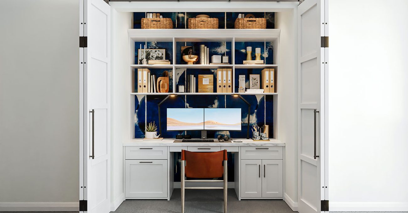 Built-in work station into closet with open shelving and integrated LED lighting.