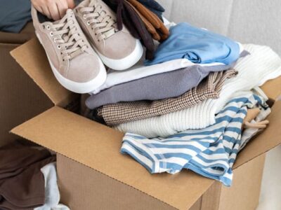 clothes being packed inside a shipping box