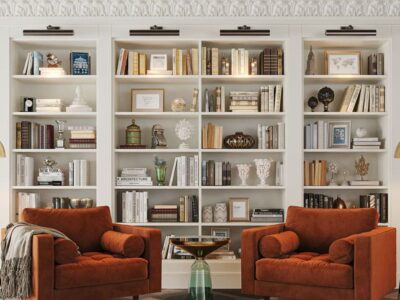Custom. white library wall unit with two reading chairs set in front
